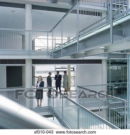 Stock Image - Business people looking at an office. Fotosearch