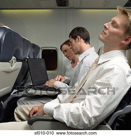 Business people on an aeroplane View Large Photo Image Stock Image - Business people on an aeroplane. Fotosearch