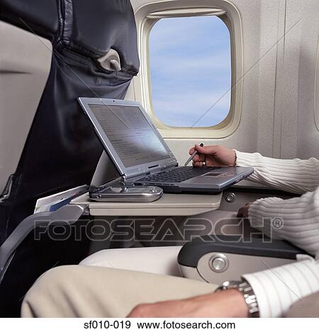 Business people on an aeroplane View Large Photo Image Stock Photo - Business people on an aeroplane. Fotosearch