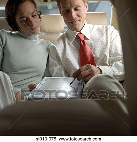 Business people using laptop in taxi View Large Photo Image Stock Photography - Business people using laptop in taxi. Fotosearch