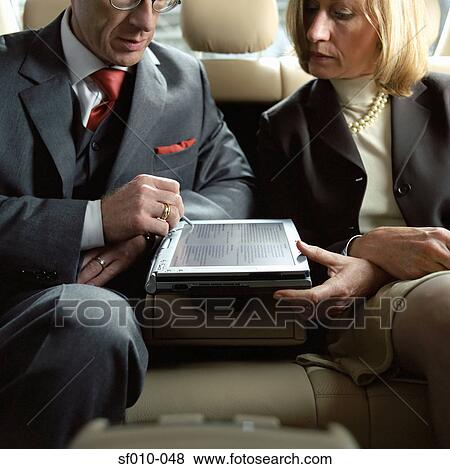 Stock Photo - Business people using laptop. Fotosearch