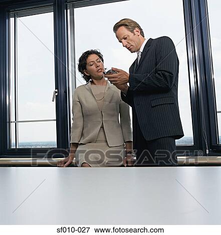 Stock Photo - Business people with palmtop. Fotosearch