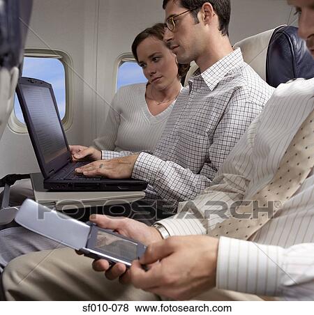 Stock Photo - Business people working on an aeroplane . Fotosearch
