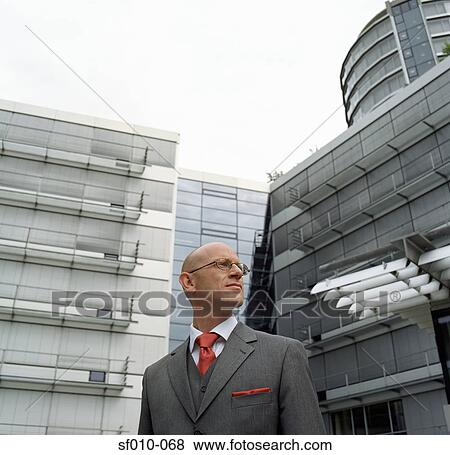Businessman outside office View Large Photo Image Stock Photo - Businessman outside office. Fotosearch
