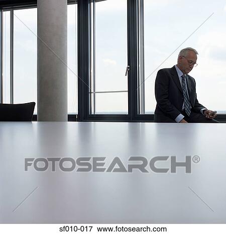 Stock Photo - Businessman using mobile phone. Fotosearch