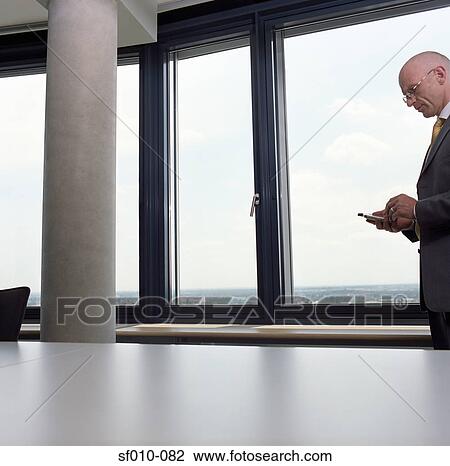 Businessman using palmtop View Large Photo Image Stock Image - Businessman using palmtop. Fotosearch