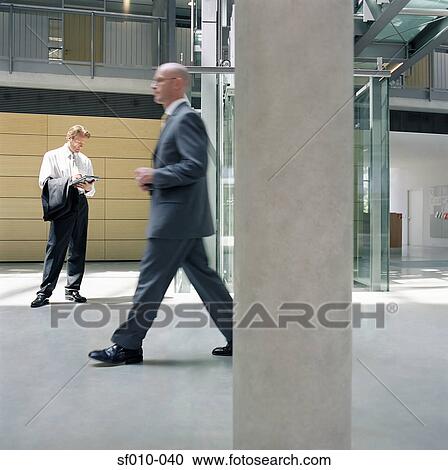 Businessmen in office lobby View Large Photo Image Stock Image - Businessmen in office lobby. Fotosearch