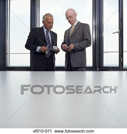 Businessmen looking at palmtop View Large Photo Image Stock Image - Businessmen looking at palmtop. Fotosearch