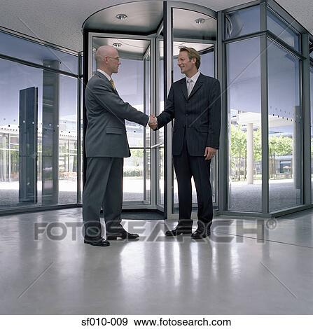 Stock Photo - Businessmen shaking hands. Fotosearch