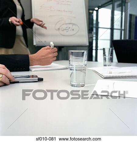 Stock Image - Businesswoman giving presentation. Fotosearch