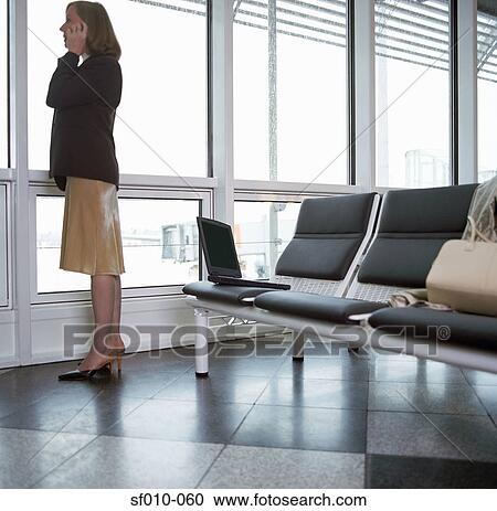 Businesswoman using mobile phone in departure lounge View Large Photo Image Stock Image - Businesswoman using mobile phone in departure lounge. Fotosearch