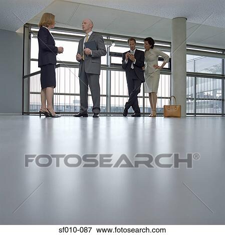 Colleagues in a corridor View Large Photo Image Stock Photo - Colleagues in a corridor. Fotosearch