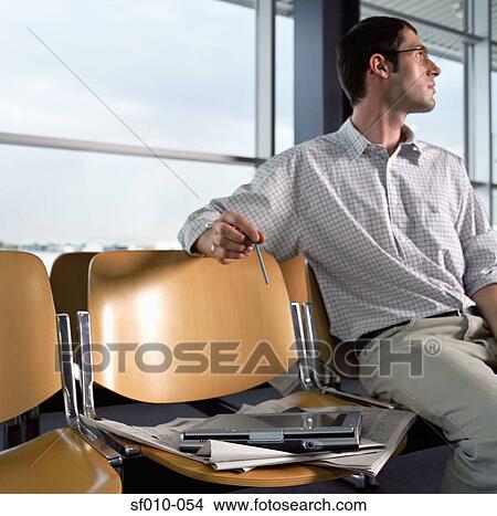 Picture - Man in departure lounge. Fotosearch