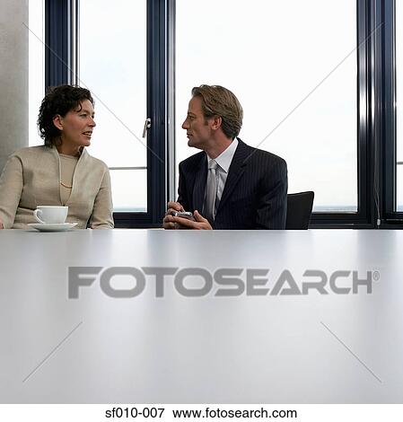 Two business people in conversation View Large Photo Image Stock Photo - Two business people in conversation. Fotosearch