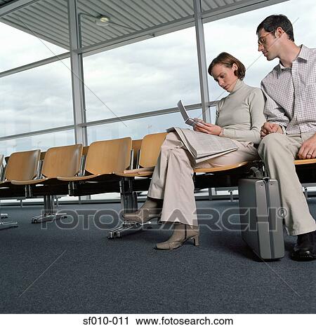 Two colleagues in a departure lounge View Large Photo Image Stock Image - Two colleagues in a departure lounge. Fotosearch