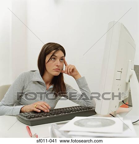 Bored looking office worker View Large Photo Image Stock Image - Bored looking office worker. Fotosearch