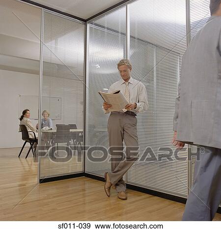 Stock Photo - Businessman reading a newspaper. Fotosearch