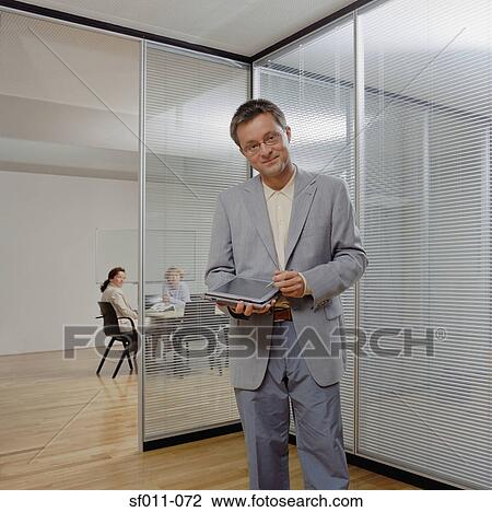 Stock Image - Businessman using a handheld computer. Fotosearch