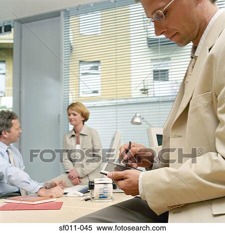 Stock Photography - Businessman using a handheld computer. Fotosearch