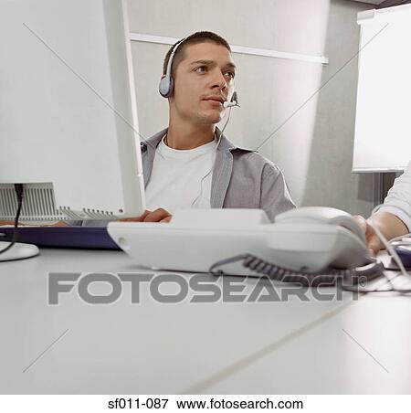 Stock Photo - Male call centre operator. Fotosearch