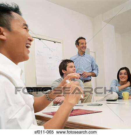Stock Photography - Office colleagues laughing. Fotosearch