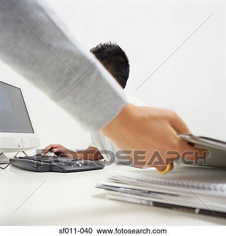 Office worker reaching for file View Large Photo Image Stock Image - Office worker reaching for file. Fotosearch