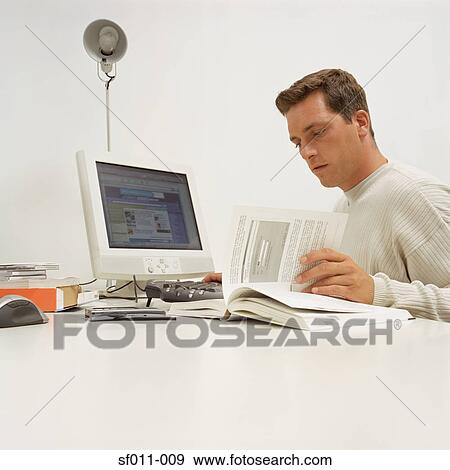 Office worker reading a book View Large Photo Image Stock Photo - Office worker reading a book. Fotosearch