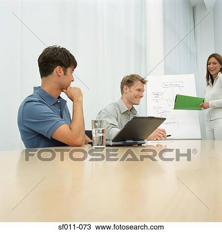 Stock Image - Office workers in meeting. Fotosearch