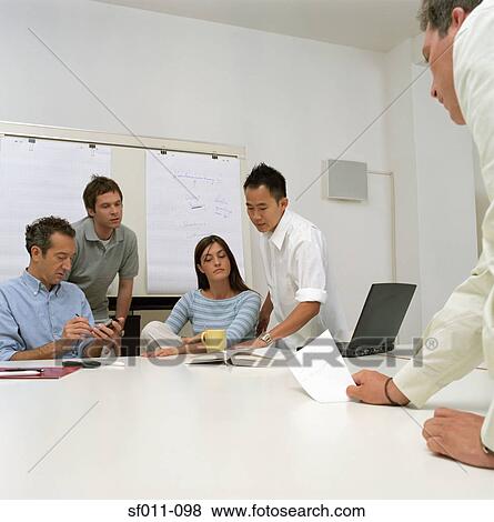 Office workers in meeting View Large Photo Image Stock Photo - Office workers in meeting. Fotosearch