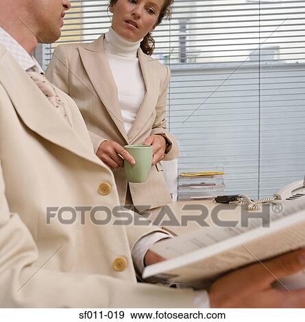 Office workers reading book View Large Photo Image Stock Photo - Office workers reading book. Fotosearch