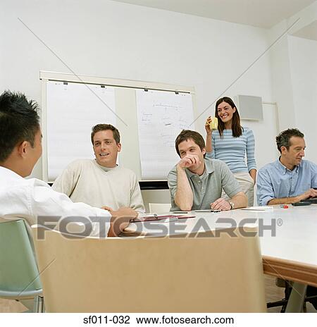 Stock Image - Office workers talking. Fotosearch