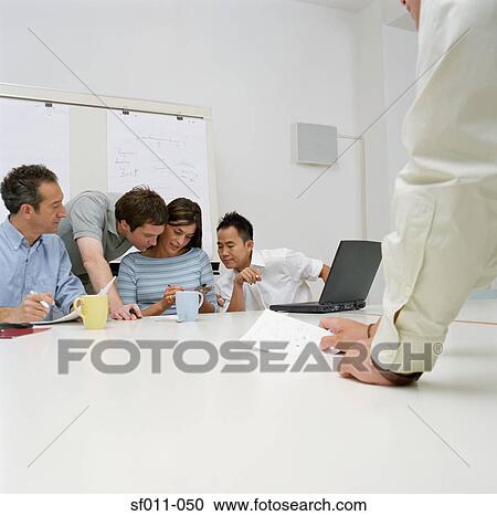 Office workers using a handheld computer View Large Photo Image Stock Image - Office workers using a handheld computer. Fotosearch