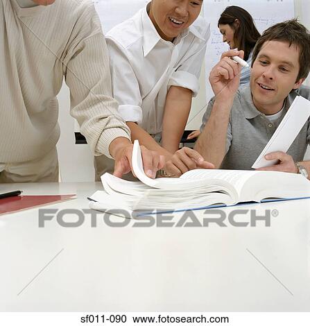 Office workers with large book View Large Photo Image Stock Image - Office workers with large book. Fotosearch