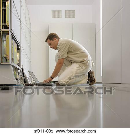 Technician working on server View Large Photo Image Stock Photography - Technician working on server. Fotosearch