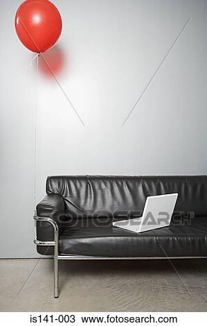 Stock Image - Balloon and laptop on a sofa. Fotosearch