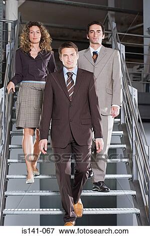 Business people walking down the stairs View Large Photo Image Stock Photo - Business people walking down the stairs . Fotosearch