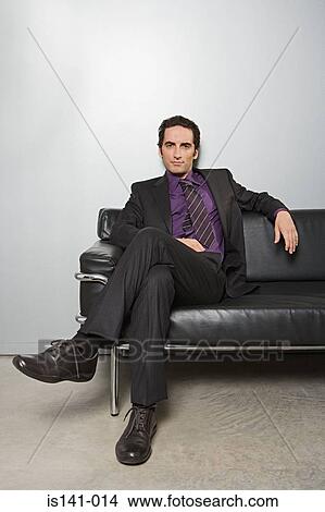 Picture - Businessman sitting on sofa. Fotosearch