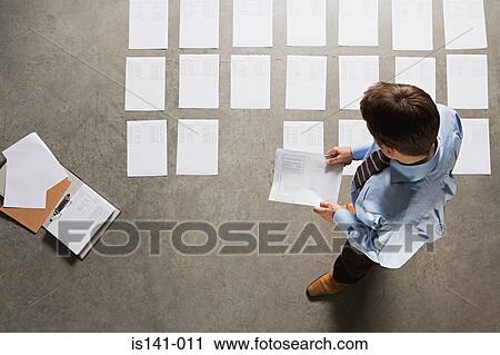 Stock Image - Businessman with papers on the floor. Fotosearch