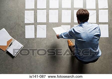 Businessman with paperwork View Large Photo Image Stock Photo - Businessman with paperwork. Fotosearch