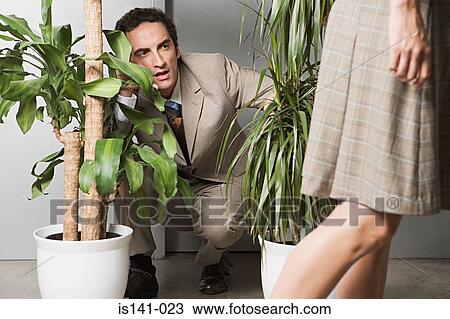 Man hiding in plants and watching woman View Large Photo Image Stock Image - Man hiding in plants and watching woman. Fotosearch