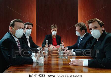Stock Image - Masked boardroom meeting. Fotosearch