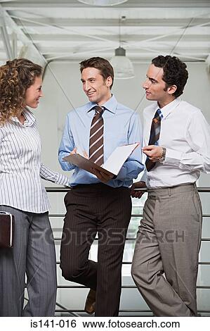Office workers discussing work View Large Photo Image Stock Photograph - Office workers discussing work. Fotosearch