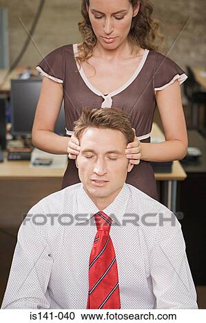 Stock Image - Woman massaging her colleague. Fotosearch