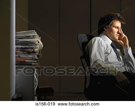 Bored man in his office View Large Photo Image Stock Photo - Bored man in his office. Fotosearch