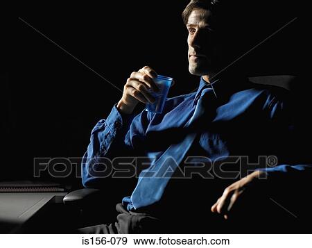 Businessman in a dark room View Large Photo Image Stock Photo - Businessman in a dark room. Fotosearch