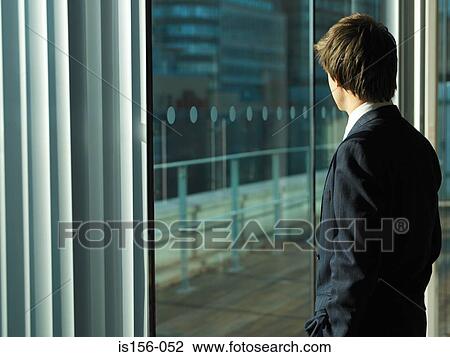 Businessman looking out of window View Large Photo Image Stock Image - Businessman looking out of window. Fotosearch
