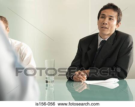 Stock Photograph - Businessmen in a meeting. Fotosearch