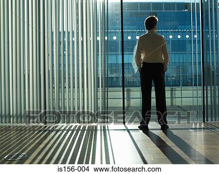 Office worker looking out of the window View Large Photo Image Picture - Office worker looking out of the window. Fotosearch