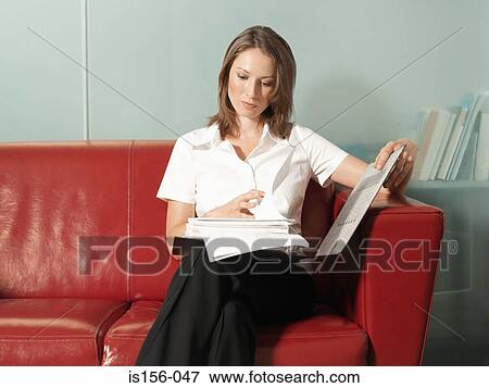 Woman reading a report View Large Photo Image Stock Photo - Woman reading a report. Fotosearch