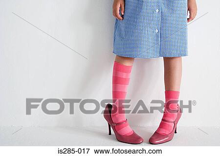 Girl wearing woman's shoes View Large Photo Image Stock Photo - Girl wearing woman's shoes. Fotosearch
